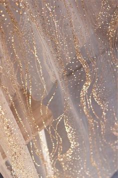 the curtains are covered with gold glitter