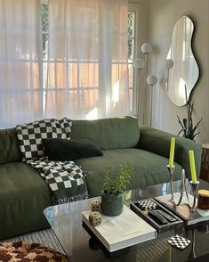 a living room with a couch, coffee table and mirror on the wall above it