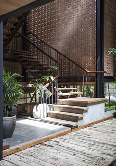 an outdoor area with stairs and potted plants