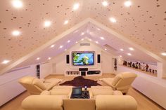 a living room filled with furniture and a flat screen tv mounted on the wall above it