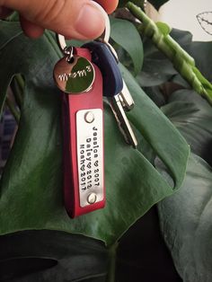 a person is holding a keychain that says, i love you and has two keys attached to it