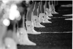 black and white photograph of rows of boots lined up