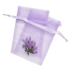 two purple bags with flowers on them sitting next to each other in front of a white background