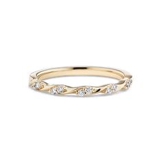 a yellow gold wedding band with diamonds