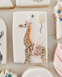 decorated cookies are arranged in the shape of giraffes