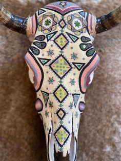 an animal's skull is decorated with colorful designs