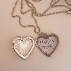 two heart shaped lockes with writing on them are shown next to an open one