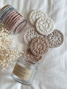 several crocheted coasters and a jar on a bed