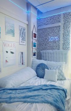 a bedroom with blue and white decor on the walls