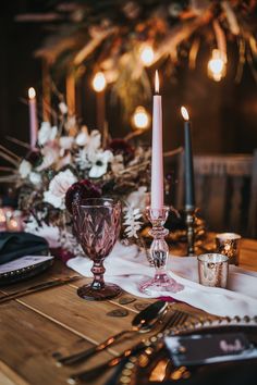 the table is set with candles and other items for an elegant dinner or party setting