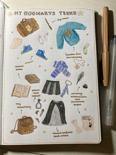 an open notebook with drawings of clothing and accessories on it next to a ballpoint pen