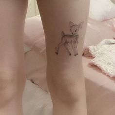 a woman's legs with a small tattoo of a deer on the lower leg