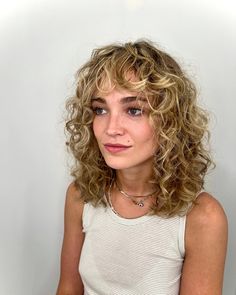 When it comes to hairstyles that effortlessly blend style and ease, few can rival the allure of curly shaggy hair. This iconic look has made a signifi... Blonde Balayage Grey Coverage, Short Curly Blonde Balayage, Curly Hairstyles Shag, Short Blonde Curly Hair With Bangs, Short Curly Hairstyles Blonde, Shaggy Bob Hairstyles Curly Hair, Perm Shoulder Length Hair, Short Curly Balayage Hair, Shaggy Short Hair Curly