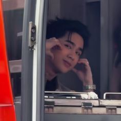 a woman sitting in the passenger seat of a bus with her hand on her head