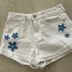 Very Different Pacsun Shorts. Crisp White With Denim Flowers. Look Much Nicer In Person. Five Pocket Jean Style. Frayed, Cuffed Hem. Waist - Side To Side - 12 1/2 Inches - Length - Top To Bottom - 12-13 Inches Pristine Condition - Never Worn (Too Small), Cleaning Closet! Size On Tag - 25 Inches (True To Size) Trendy White Denim Shorts, White Denim Jean Shorts For Summer, White High-waist Jean Shorts For Summer, White High Waist Jean Shorts For Summer, Summer White High Waist Jean Shorts, High Waist Cotton Shorts For Beach, High Waist Cotton Beach Shorts, White Cotton Jean Shorts For Summer, Blue Cotton Summer Jean Shorts