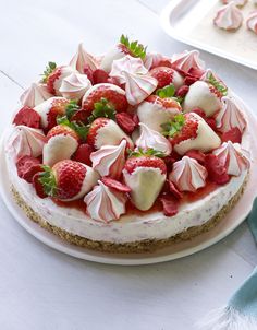 a cake with strawberries and cream on top