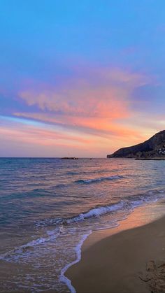 the sun is setting over the water at the beach