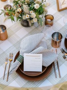 a table set with place settings, napkins and silverware