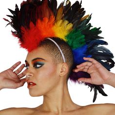 PRICES MAY VARY. Feather Headpiece: Make a bold statement at Pride with this striking feather mohawk from Zucker, featuring 6-8” rooster feathers and trimmed with a medium-weight boa. Perfect for adding flair to your Pride ensemble Comfortable Feather Headband: The mohawk base, crafted from buckram, felt, and wire, includes 1” elastic loops at each end and one in the center crown. A ¾” elastic strap loops through the front, ensuring a secure and comfortable fit for all-day Pride festivities Perf Natural Mohawk, Feather Mohawk, Rainbow Costume, Carnival Headdress, Rainbow Costumes, Rainbow Feather, Feather Headpiece, Party Hair Accessories, Feather Headdress