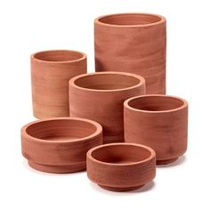 four clay cups and one bowl are shown