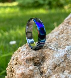 Handmade Timascus Ring - A Kaleidoscope of Elegance  🌟 **Unique Beauty in Every Angle** 🌟 Introducing our handcrafted Timascus ring, where artistry meets the strength of titanium. Each piece is meticulously forged to create a stunning array of vibrant colors and patterns that dance in the light. Perfect for those who appreciate individuality and exquisite craftsmanship. 💍 **Features - **Material Timascus (Titanium Damascus) - **Design Unique color patterns with a mirror-polished finish - **Du Titanium Promise Ring, Modern Iridescent Round Ring, Modern Iridescent Round Rings, Adjustable Iridescent Rings, Timascus Ring, Les Angles, Unique Beauty, Unique Colors, L Art