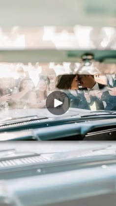 a man and woman are kissing in the back seat of a car while others look on