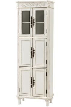 a tall white cabinet with glass doors