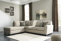 a living room with a sectional couch and rug