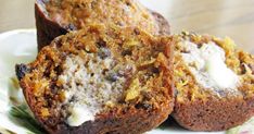 two muffins sitting on top of a white and green flowered plate next to each other