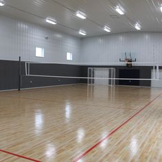 an indoor basketball court with hard wood floors and white walls is pictured in this image