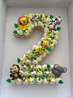 the number two is made out of cupcakes and decorated with animals on it