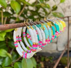 a bunch of bracelets hanging from a tree branch