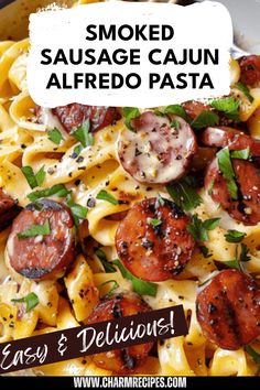 a plate of pasta with tomatoes and basil on top, next to the words smoked sausage cajun alfredo pasta