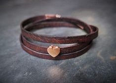 A brown leather wrap bracelet with a beautiful rose-golden heart charm. It comes gift wrapped in a handmade Origami envelope and a colour matching organza pouch. A little handwritten note can be added for that extra personal touch.   It is 5mm wide and 51 - 54cm long (adjustable with a chain extender) The bracelet wraps around the wrist 3 times. The bracelet is made from real leather, can vary in texture and colour and has a nice "vintage effect". Also available in black or tan leather. Origami Envelope, Brown Leather Bracelet, Organza Pouch, Bracelet Heart, Colour Matching, Golden Heart, Turquoise Leather, Cabochon Jewelry, Chain Extenders