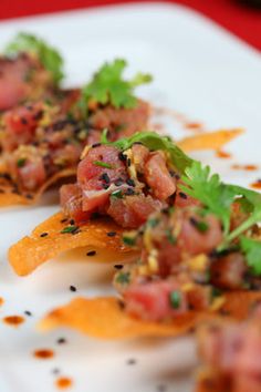 two pieces of food on a white plate with garnishes and parsley