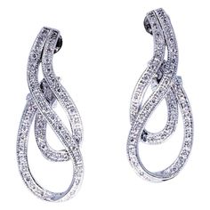 Art Deco 1.20 Carats Diamond Earrings. The earrings have a beautiful design swiveling around making it stand out with the bright diamonds approximately weighing in total 1.20 carats. The earrings are crafted in 18 karat solid gold & weight 13.5 grams. The earrings measure 14.75mm X 37.5mm. The earrings also feature back clip backs for maximum secured fit. Baguette Diamond Earrings, Art Deco Drop Earrings, Gold Diamond Drop Earrings, Diamond Cluster Earrings, Diamond Cocktail Rings, Diamond Drop Earrings, Art Deco Earrings, Diamond Drops, Diamond Flower