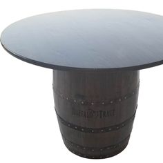 a wine barrel table with a glass top and metal base on an isolated white background