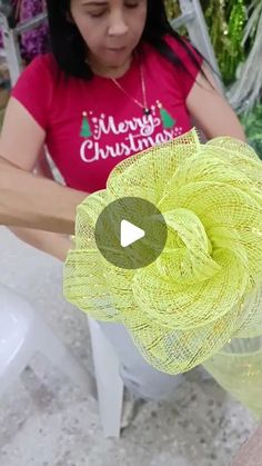 a woman is working with yarn on a table