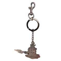 a metal keychain with a house on it and a bird hanging from the front