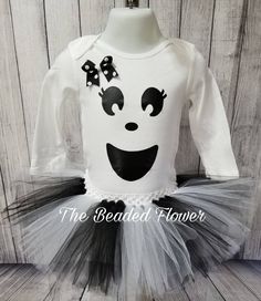 "Halloween Orders Last day to order for guarantee delivery for halloween will be Oct. 22. Thank you. This adorable ghost costume will look adorable on any little one. Please select the size needed when ordering. Top will be a long sleeve bodysuit/shirt with a ghost face vinyl image on the front. The tutu skirt will be all white, white/black, or all black made on a crochet band with two layers of tulle and a removable bow on an alligator clip. A cute bow will be added above the right eye, if you Cute Halloween Tulle Tutu Dress, Cute Halloween Costume Tutu Dress, Cute Tutu Dress For Halloween Costume, Fitted White Tutu Dress For Costume Party, White Fitted Tutu Dress For Costume, Baby Costumes Girl, Halloween Tutu, Ghost Costume, Bodysuit Shirt