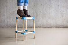 a person standing on top of a wooden stool