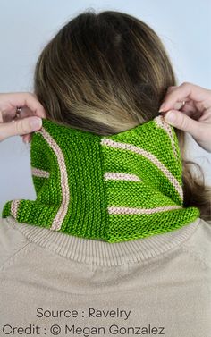 a woman wearing a green knitted neck scarf