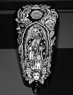 a black and white image of the virgin mary with angels on it's back