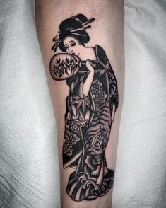 a black and white tattoo on the leg of a woman with flowers in her hair