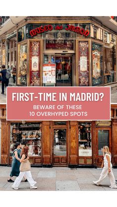 two women walking past a store front with the words first - time in madrid? beware of these 10 overhyped spots