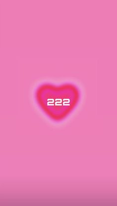 a pink heart with the number 22 on it's left side, in front of a pink background