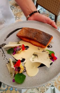 a plate with some food on it and a person holding the plate in their hand