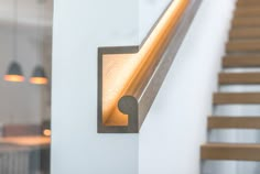 a light that is on the side of a wall next to some stairs and steps