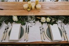 the table is set with silverware and place settings