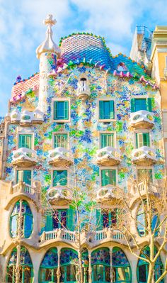 the facade of a building with many windows and balconies on it's sides